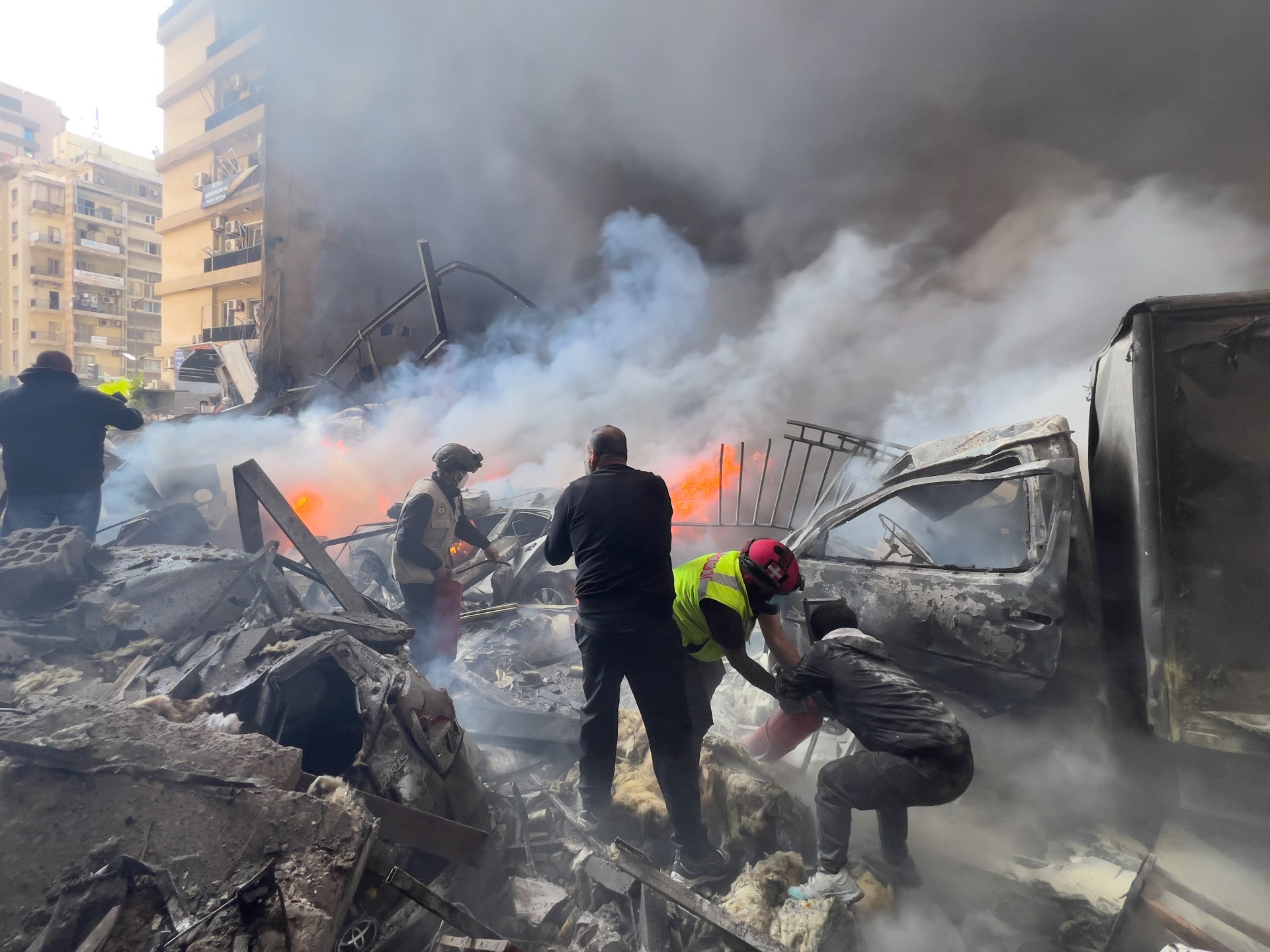 Civilians gather in the aftermath of Israeli airstrikes on central Beirut on April 8, 2026. Every combatant announces its dead through a mirrored script: inflate the enemy, bury your own, deny the civilian massacres, publicize the senior kills. (AP via Al Jazeera)